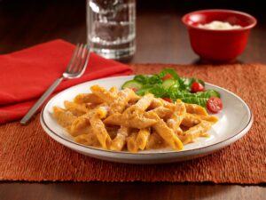 Penne pasta coated in a creamy pumpkin sauce