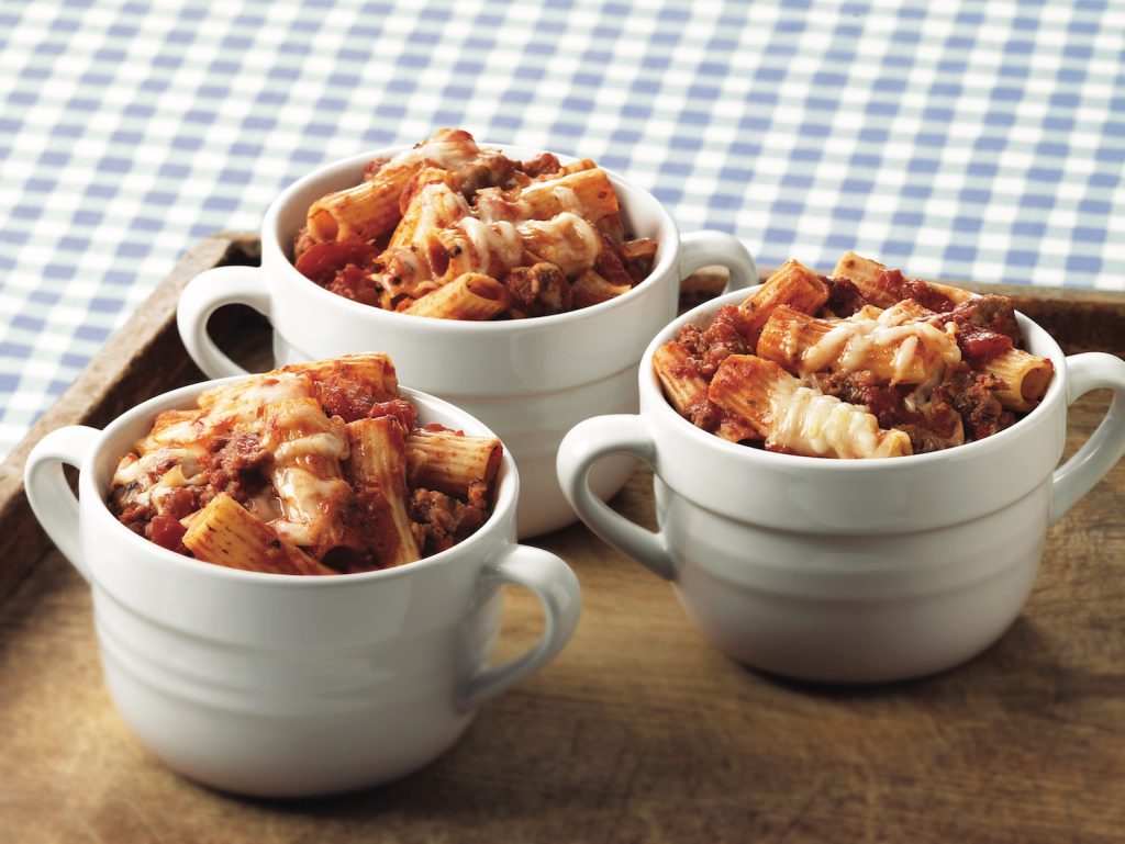 Rigatoni pasta coated in marinara sauce, topped with cheese, and baked in a ramekin