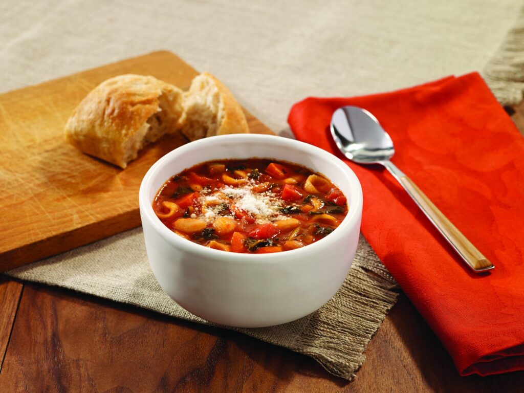 Minestrone soup with shells, vegetables, white beans, and kale