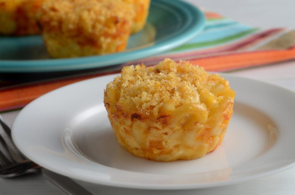 Macaroni and cheese formed into bite-size muffins and sprinkled and baked with panko bread crumbs